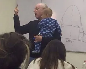 photo of professor holding student's baby