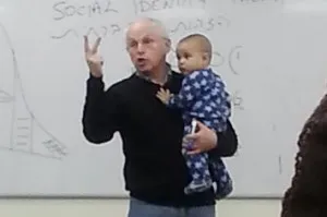 photo of professor holding student's baby
